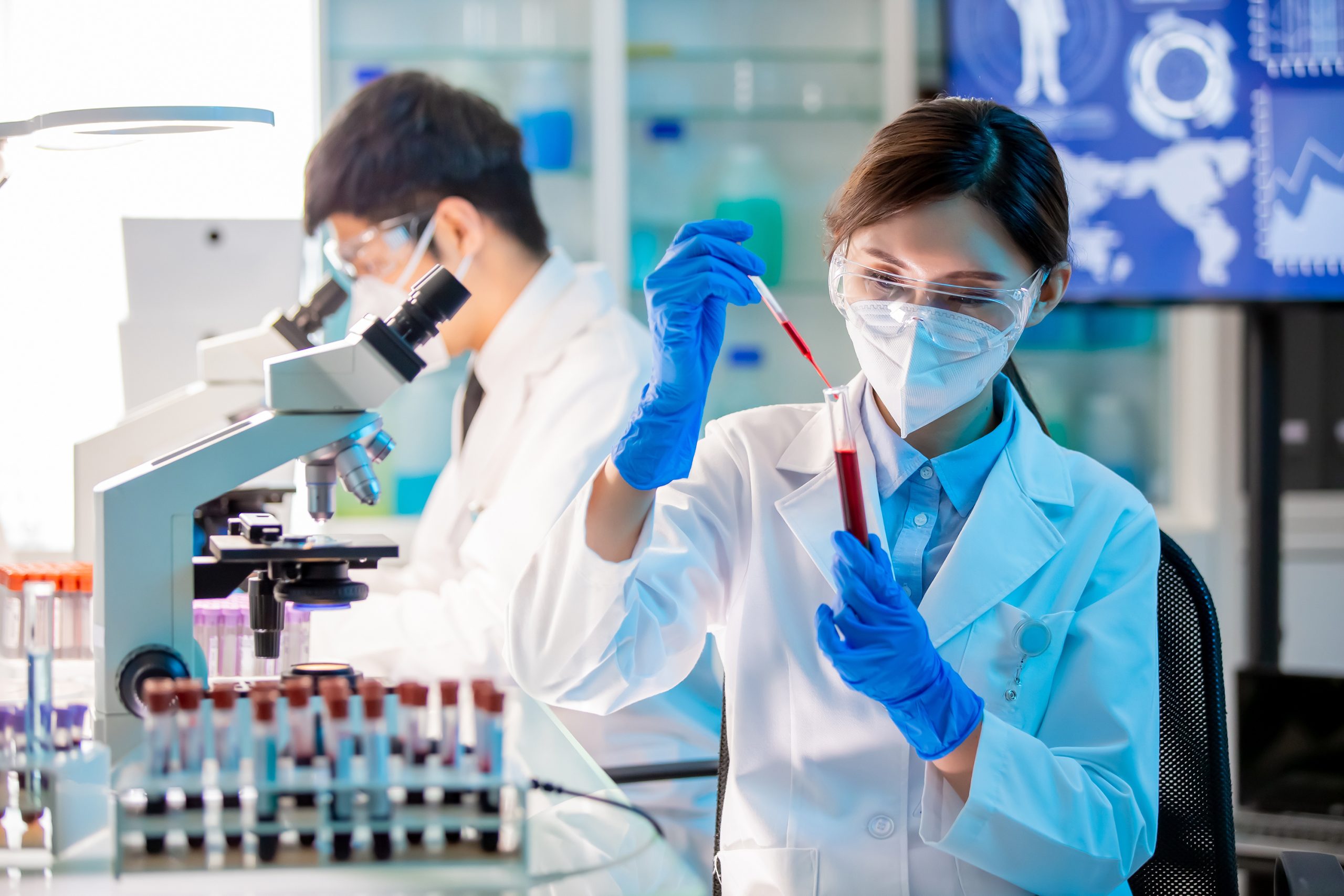 microbiologist or medical worker use test tube filling with blood in the laboratory